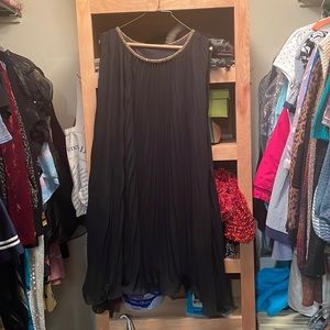 Black pleated dress with gold beaded neckline.